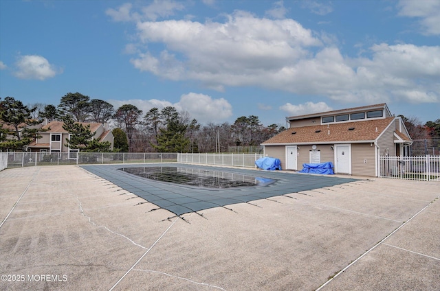 pool with a patio and fence