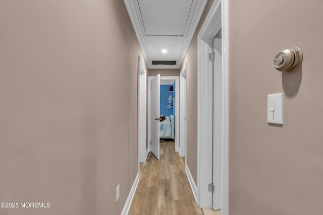 hall with baseboards and light wood-type flooring