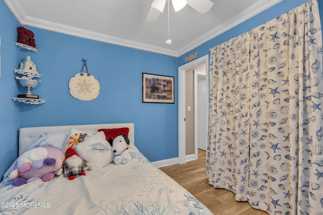 bedroom featuring crown molding, wood finished floors, ceiling fan, and baseboards