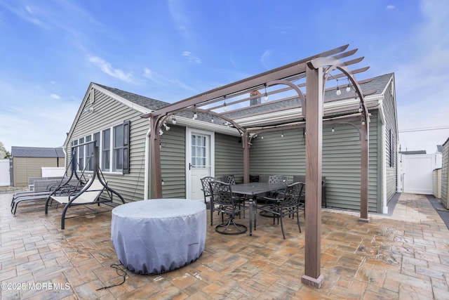 view of patio / terrace featuring a pergola, outdoor dining area, and fence