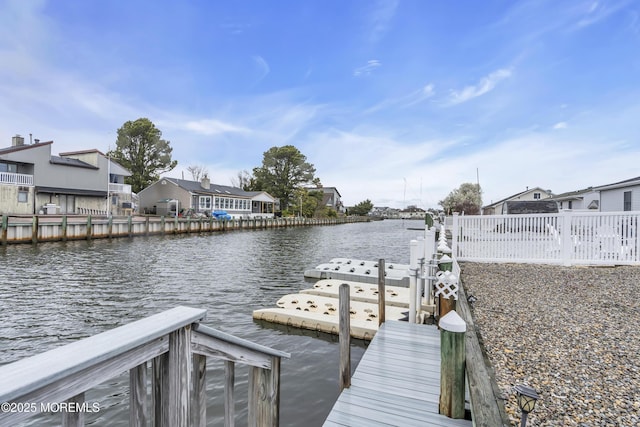 view of dock featuring a residential view and a water view