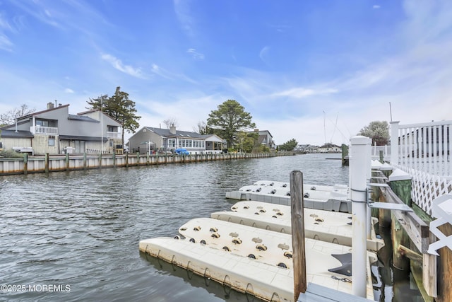dock area with a residential view and a water view
