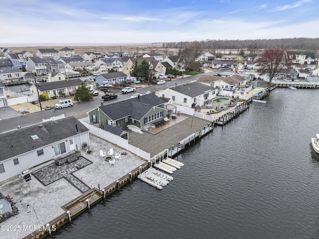 bird's eye view featuring a water view and a residential view