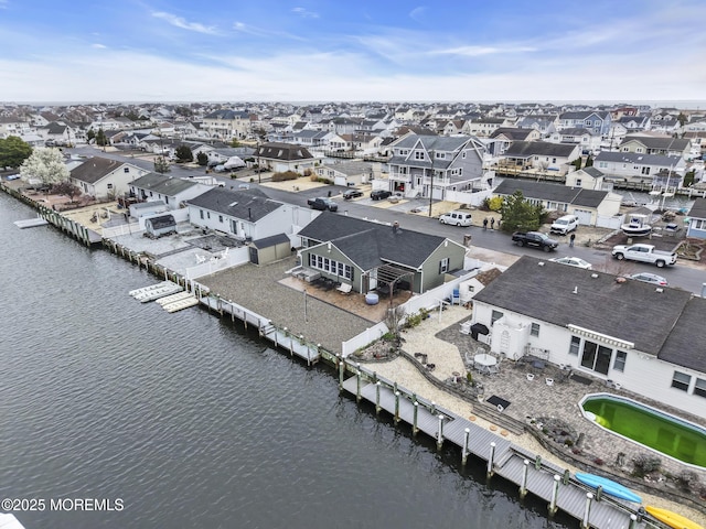 bird's eye view featuring a water view and a residential view