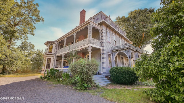 6056 Main St, Hamilton, NJ 08330 - italianate home with a chimney, covered porch, and a balcony