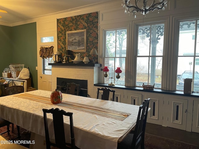 6056 Main St, Hamilton, NJ 08330 - dining space with crown molding, a healthy amount of sunlight, a notable chandelier, and a brick fireplace