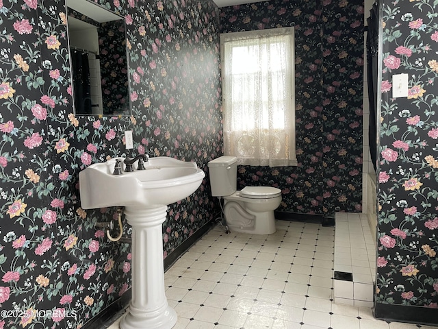 6056 Main St, Hamilton, NJ 08330 - bathroom with tile patterned floors, baseboards, wallpapered walls, and toilet