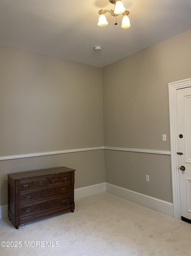 6056 Main St, Hamilton, NJ 08330 - carpeted spare room featuring an inviting chandelier and baseboards