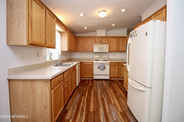 kitchen featuring white appliances, dark wood-style floors, light countertops, lofted ceiling, and a sink