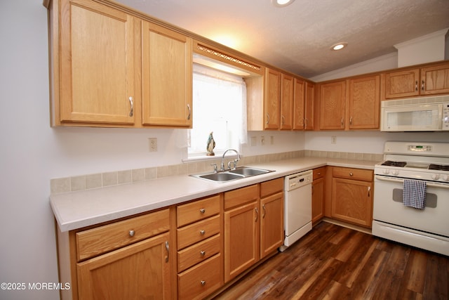 kitchen with white appliances, dark wood-type flooring, light countertops, a sink, and lofted ceiling