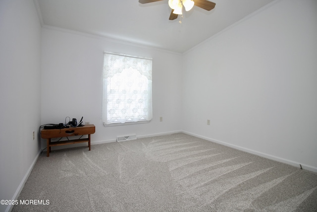 unfurnished room with crown molding, ceiling fan, visible vents, and carpet floors