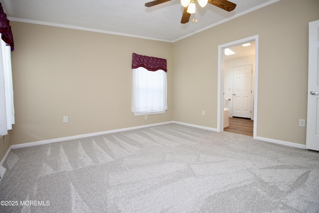 carpeted empty room with ornamental molding, ceiling fan, and baseboards
