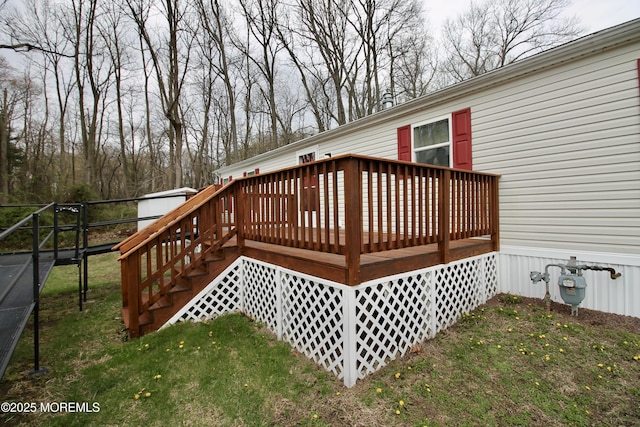 wooden terrace featuring a lawn