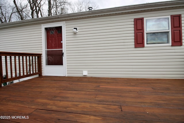 view of exterior entry with a wooden deck
