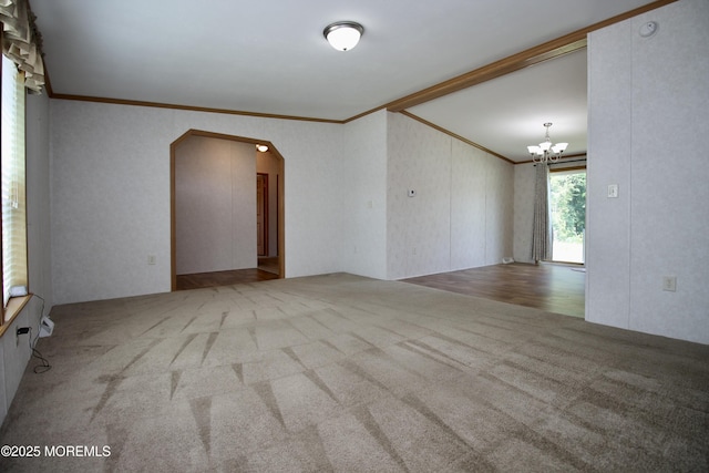 2 Brookside Way, Freehold, NJ 07728 - spare room featuring crown molding, carpet, arched walkways, and a chandelier