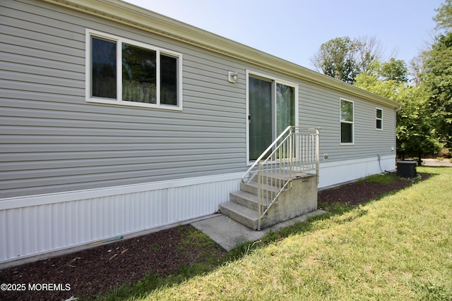 2 Brookside Way, Freehold, NJ 07728 - view of exterior entry featuring a yard and cooling unit