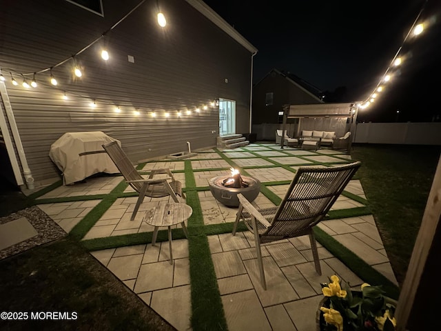patio at twilight with entry steps, an outdoor living space with a fire pit, and fence