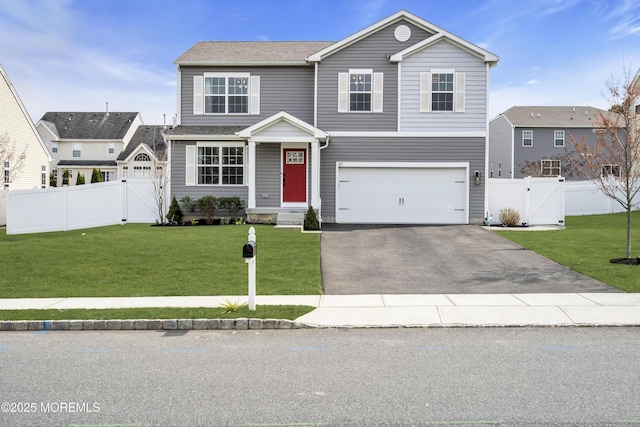 traditional-style house featuring an attached garage, aphalt driveway, fence, and a gate