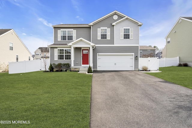 traditional-style home featuring a garage, a front yard, aphalt driveway, and fence