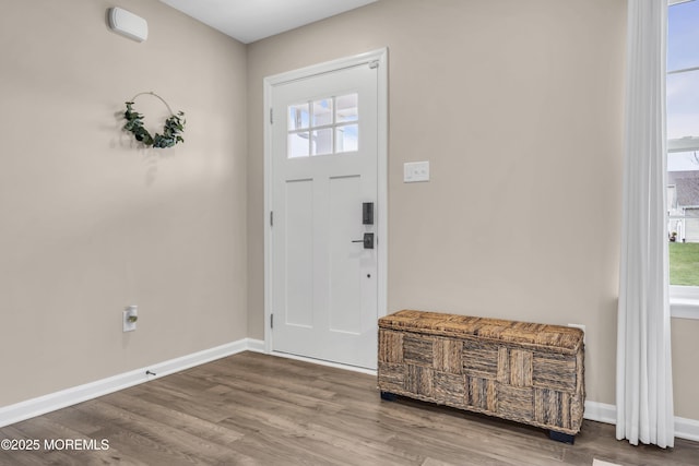 entryway featuring baseboards and wood finished floors