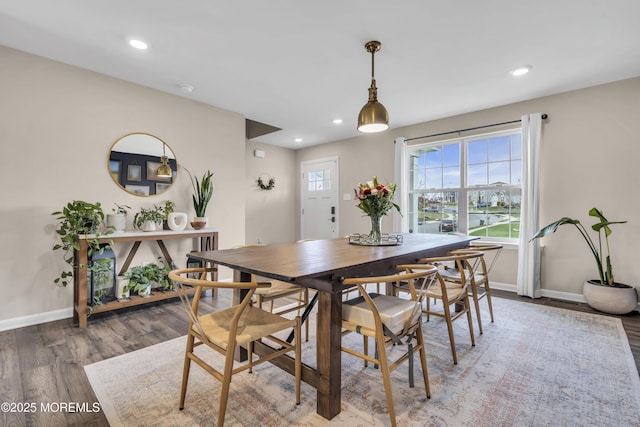 dining room featuring wood finished floors, baseboards, and recessed lighting