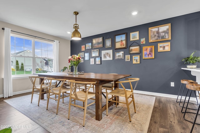 dining space with wood finished floors, baseboards, and recessed lighting