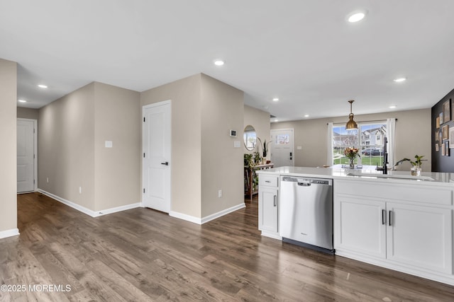 kitchen featuring stainless steel dishwasher, hanging light fixtures, white cabinets, dark wood finished floors, and baseboards