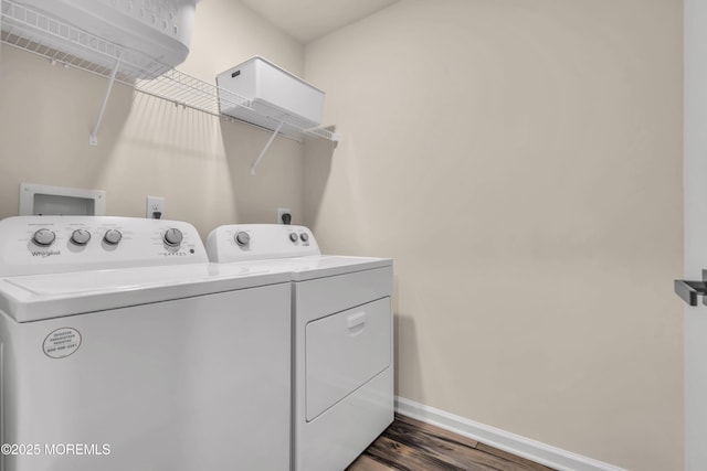 laundry area featuring wood finished floors, baseboards, washer and clothes dryer, and laundry area