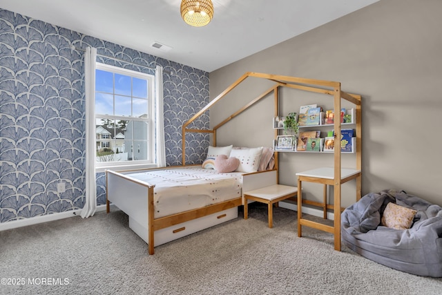 carpeted bedroom with wallpapered walls, visible vents, and baseboards