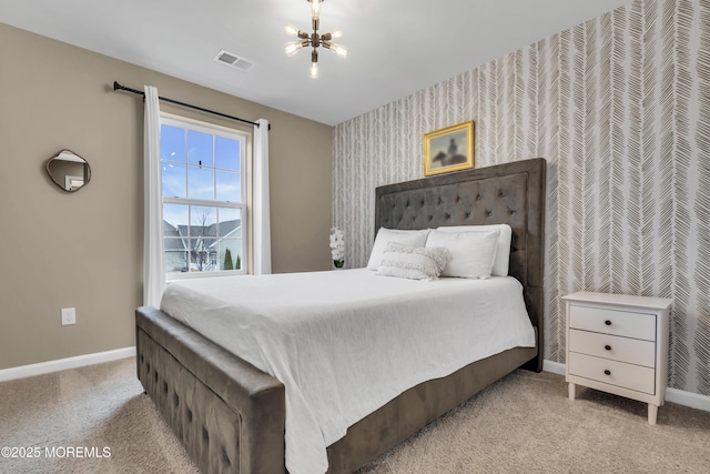 bedroom featuring baseboards, visible vents, a chandelier, and carpet flooring