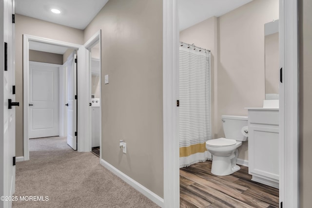 bathroom with vanity, toilet, baseboards, and a shower with curtain