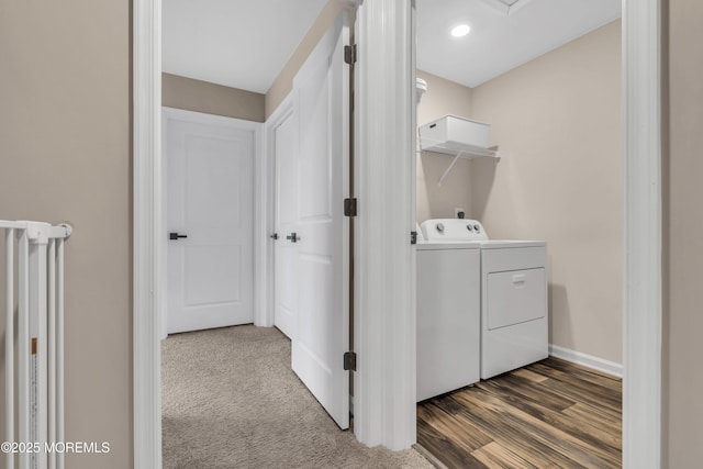 washroom featuring washing machine and dryer, baseboards, and laundry area