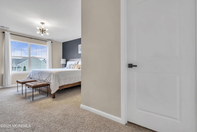 bedroom with baseboards, carpet flooring, and an inviting chandelier