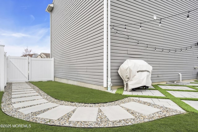 view of yard featuring fence and a gate