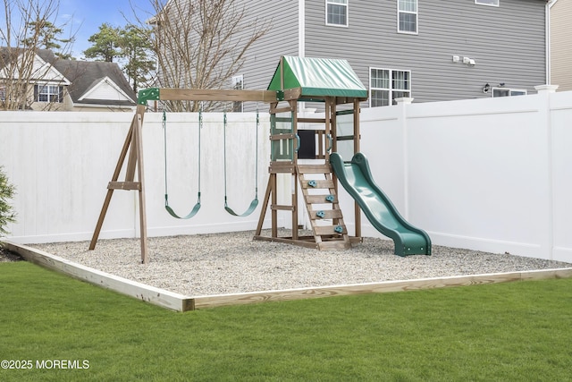 view of playground with a yard and fence