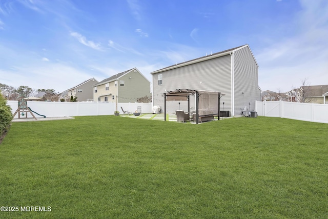 rear view of house with a pergola, a yard, a patio area, and a fenced backyard