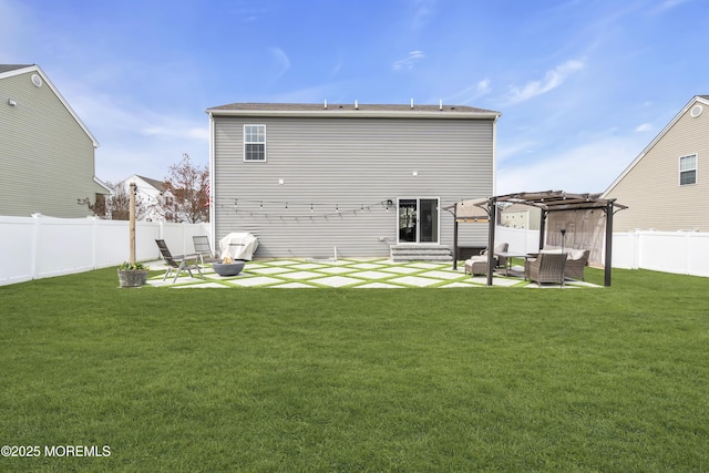 back of house with a lawn, a pergola, a fenced backyard, and a patio