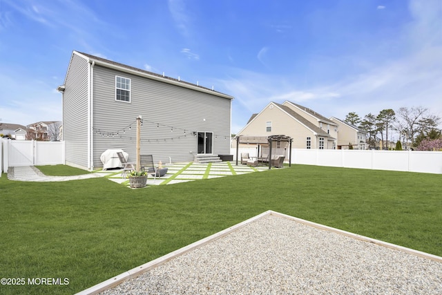 back of property featuring a lawn, a fenced backyard, a pergola, and a patio