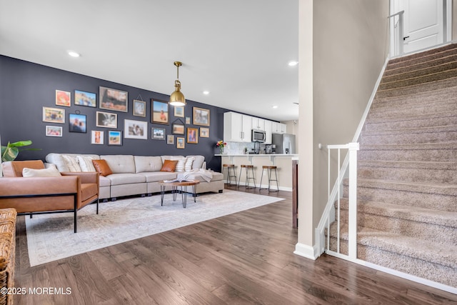 living room with baseboards, dark wood-style floors, recessed lighting, and stairs