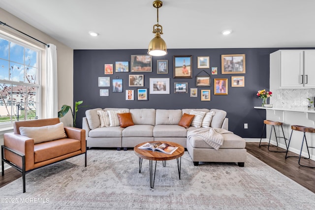 living room with recessed lighting, wood finished floors, and baseboards