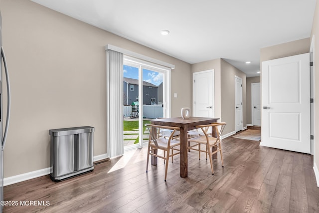 dining area with hardwood / wood-style flooring, baseboards, a wealth of natural light, and recessed lighting