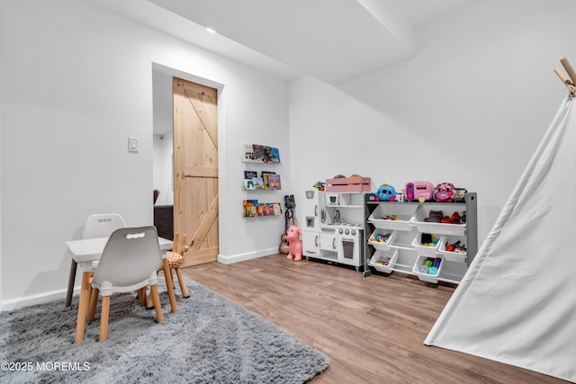 rec room featuring recessed lighting, wood finished floors, and baseboards