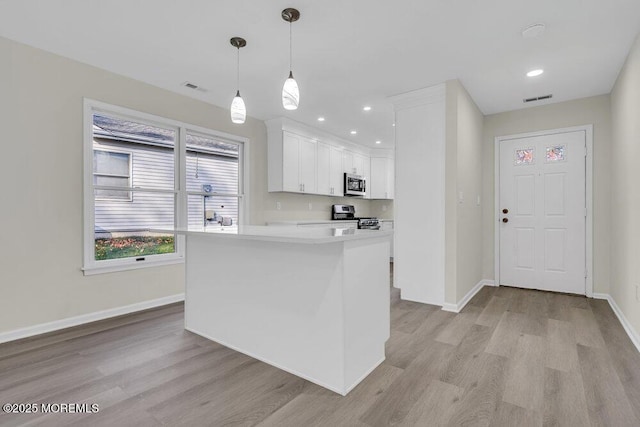 1396 Gleniffer Hill Rd, Toms River, NJ 08755 - kitchen with light wood-style floors, appliances with stainless steel finishes, baseboards, white cabinetry, and visible vents