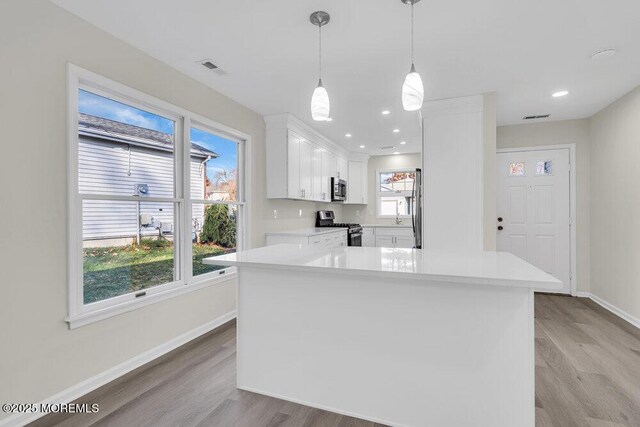 1396 Gleniffer Hill Rd, Toms River, NJ 08755 - kitchen featuring light wood-style floors, light countertops, white cabinets, baseboards, and appliances with stainless steel finishes
