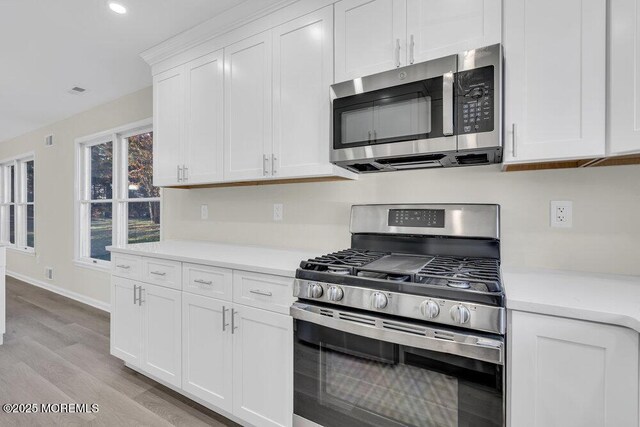 1396 Gleniffer Hill Rd, Toms River, NJ 08755 - kitchen featuring white cabinets, stainless steel appliances, light wood-style flooring, recessed lighting, and light countertops
