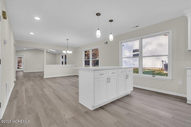 1396 Gleniffer Hill Rd, Toms River, NJ 08755 - kitchen with light wood-type flooring, light countertops, baseboards, and a notable chandelier