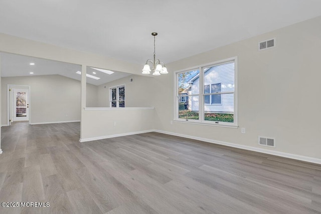 1396 Gleniffer Hill Rd, Toms River, NJ 08755 - unfurnished dining area featuring vaulted ceiling, a notable chandelier, wood finished floors, and visible vents
