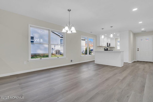 1396 Gleniffer Hill Rd, Toms River, NJ 08755 - unfurnished living room featuring recessed lighting, wood finished floors, visible vents, baseboards, and a notable chandelier