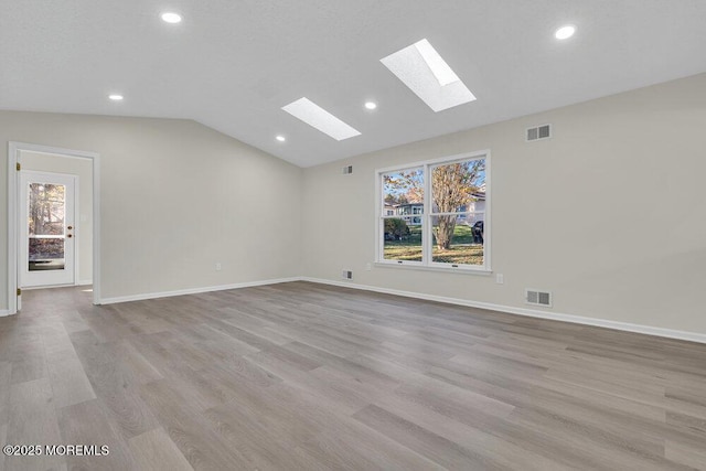 1396 Gleniffer Hill Rd, Toms River, NJ 08755 - spare room featuring recessed lighting, vaulted ceiling with skylight, and light wood-type flooring