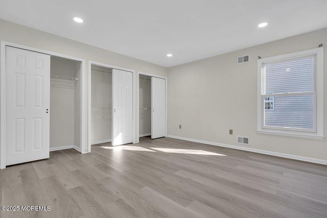 1396 Gleniffer Hill Rd, Toms River, NJ 08755 - unfurnished bedroom with baseboards, wood finished floors, visible vents, and two closets